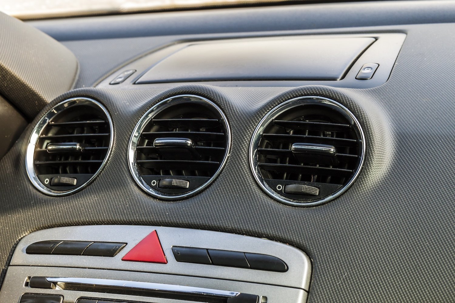Salidas de ventilación cromadas en tablero de auto — sistema de A/C vehicular
